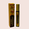 Sacred Sandalwood roll-on bottle and packaging on a beige background