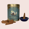 Mountain Musk incense set with incense cones and a bowl on a light pink background