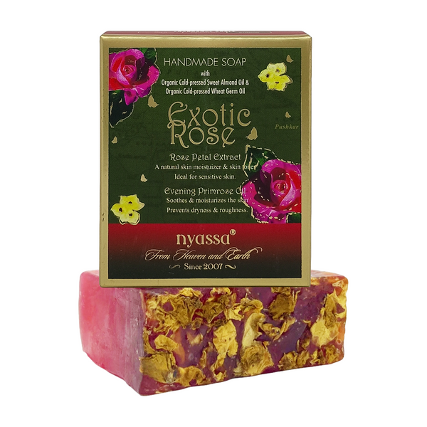 Nyassa Exotic Rose Handmade Soap, a moisturizing pink soap bar infused with real petals, displayed with its green and gold box.