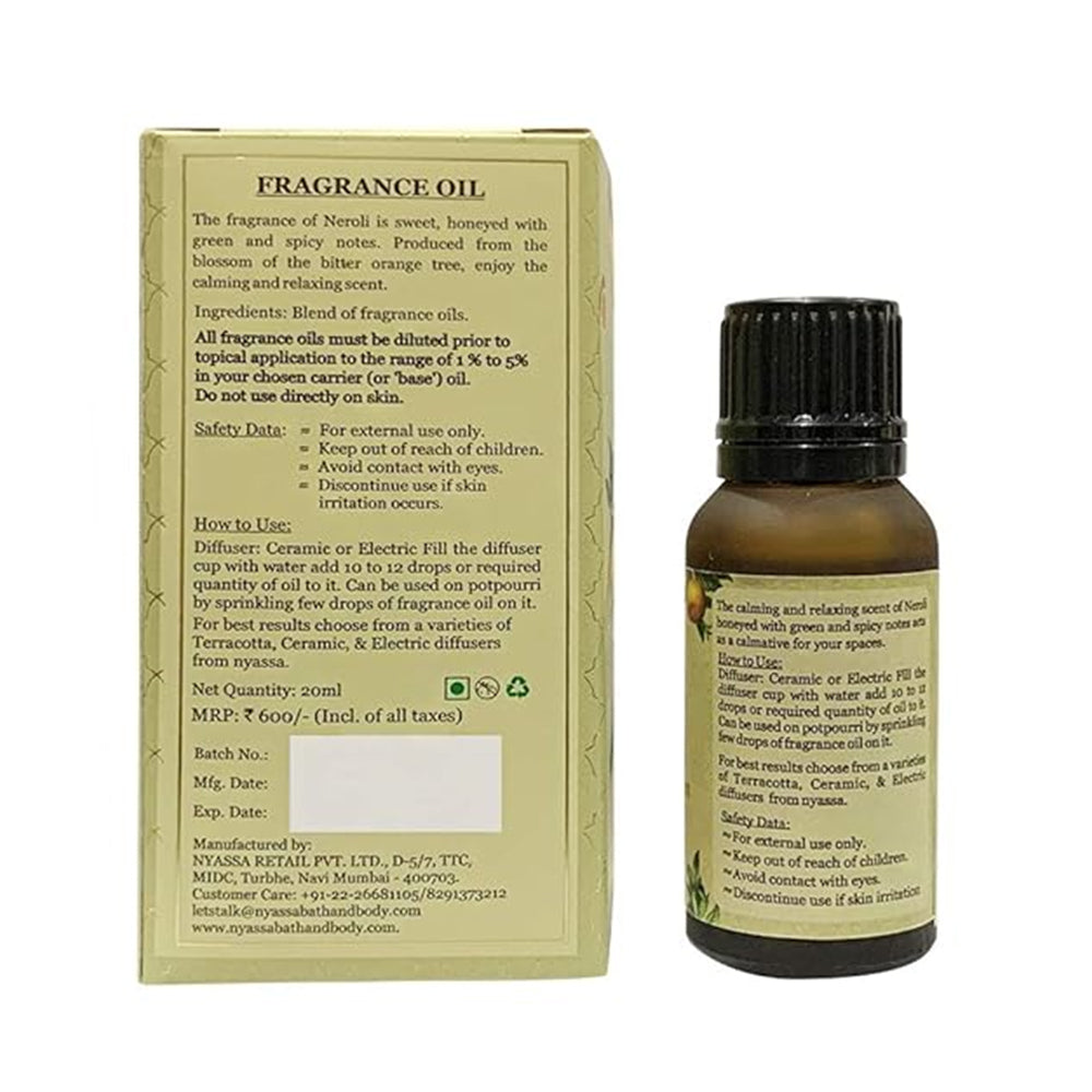 Fragrance oil bottle with label and packaging on a white background